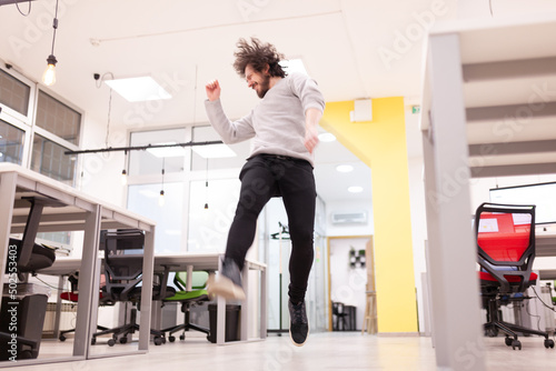 фотографія Young businessman with clumsy hair having fun at the office