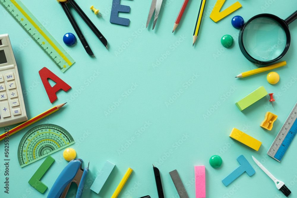 Different stationery and calendar on green table background, flat lay. Space for text, back to school concept Different stationery and calendar on green table background, flat lay. Space for text, back to school concept