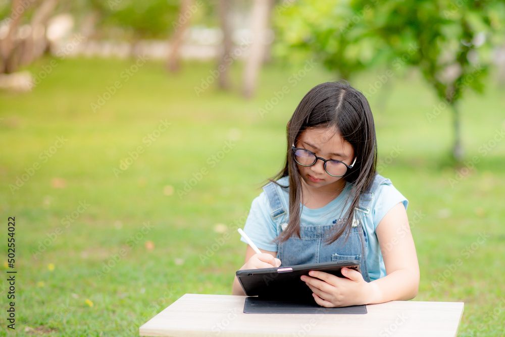 Fototapeta premium Girl studying online with tablet due to coronavirus situation