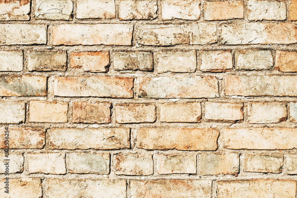 Brick wall background. Urban rustic texture. Antique house exterior wall. Vintage abandoned building architecture. Red brick construction. Uneven blocks pattern. Brick wall background. Urban rustic texture. Antique house exterior wall. Vintage abandoned building architecture. Red brick construction. Uneven blocks pattern.