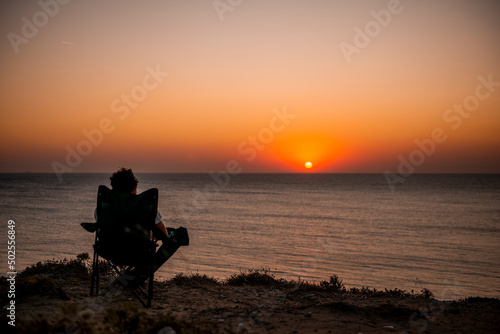 Traveler watching the sunset. Bozcaada, Turkey