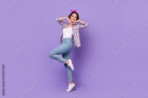 Full length profile side photo of young adorable girl good mood playful isolated over purple color background