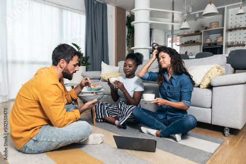 Group of freelancer business partners colleagues working at home on laptop computer. Three marketing experts chilling and work on new project at the apartment home office.