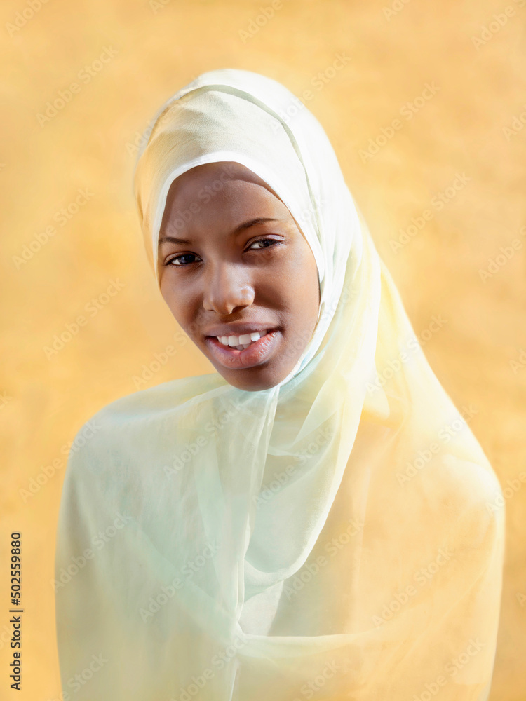 Beautiful young girl wearing a headscarf and smiling, eighteen years old, beige background, photo
Beautiful young girl wearing a headscarf and smiling, eighteen years old, beige background, photo