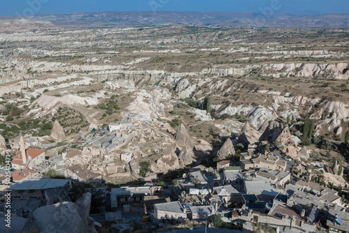 Aerial of the town of Goreme with the Rock Castle of Uchisar on the horizon, Cappadocia, Anatolia, Turkey, Asia Minor, Eurasia