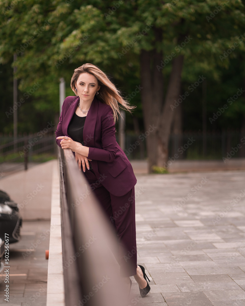 Fototapeta premium successful businesswoman in a business suit on the outside in full length