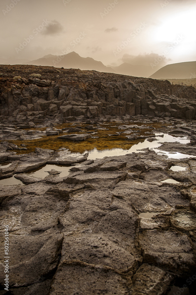 Obraz premium Volcanic rock black texture close up.