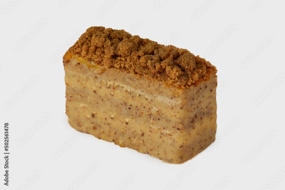 Closeup image of medovik cake with honey decorated with nuts isolated at white background. Closeup image of medovik cake with honey decorated with nuts isolated at white background.