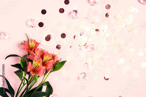 Alstroemeria flowers with confetti on pink background. Holiday, birthday, Valentine's day, Mother's day concept.