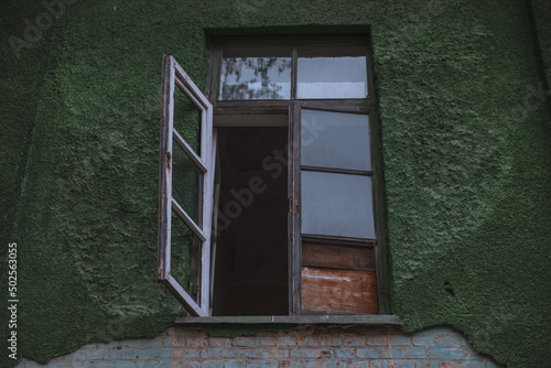 Broken glass window with old wooden frame. Old house. Damaged house.