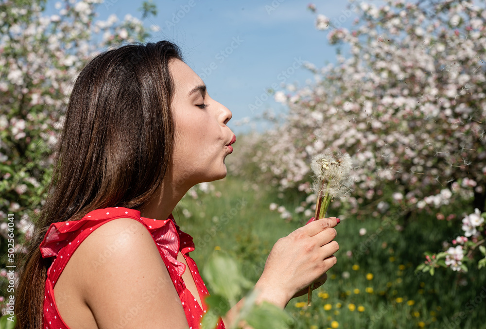 Young caucasian woman enjoying the flowering of an apple trees Young caucasian woman enjoying the flowering of an apple trees