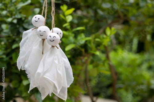 Many of smile Teru Teru Bozu on green nature background , Japanese rain doll photo