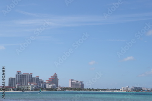 Shoreline of Goodman's Bay Beach in Nassau, Bahamas. The beautiful coastline of Goodman Bay is frequented by families with children and water sports enthusiasts. In the background the beautiful resort