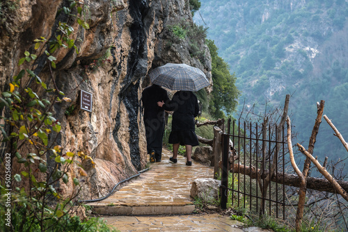 Nun and priest in Monastery of Our Lady of Qannoubine Monastery in Kadisha Valley, Lebanon photo