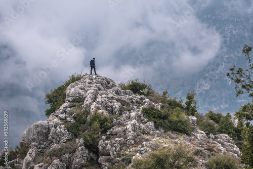 Tourist on a rock in Blouza village over Kadisha Valley in North Governorate region, Lebanon