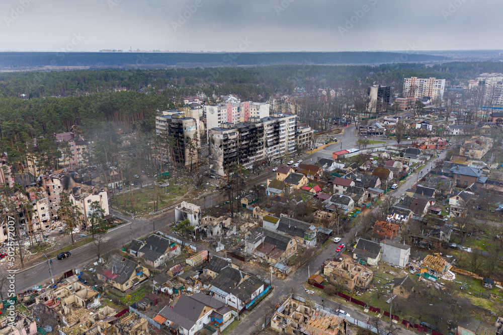 Obraz premium The aerial view of the destroyed and burnt buildings. The buildings were destroyed by russian rockets and mines. The Ukrainian cities after the russian occupation.