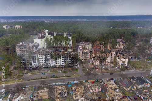 The aerial view of the destroyed and burnt buildings. The buildings were destroyed by russian rockets and mines. The Ukrainian cities after the russian occupation. #502572009