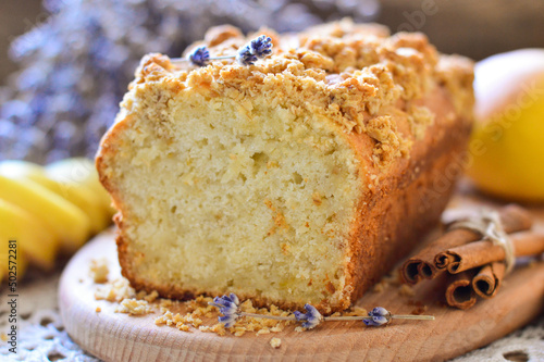 Cake in a cut. Garnished with pears and cinnamon sticks. Homemade baking. Wooden background.