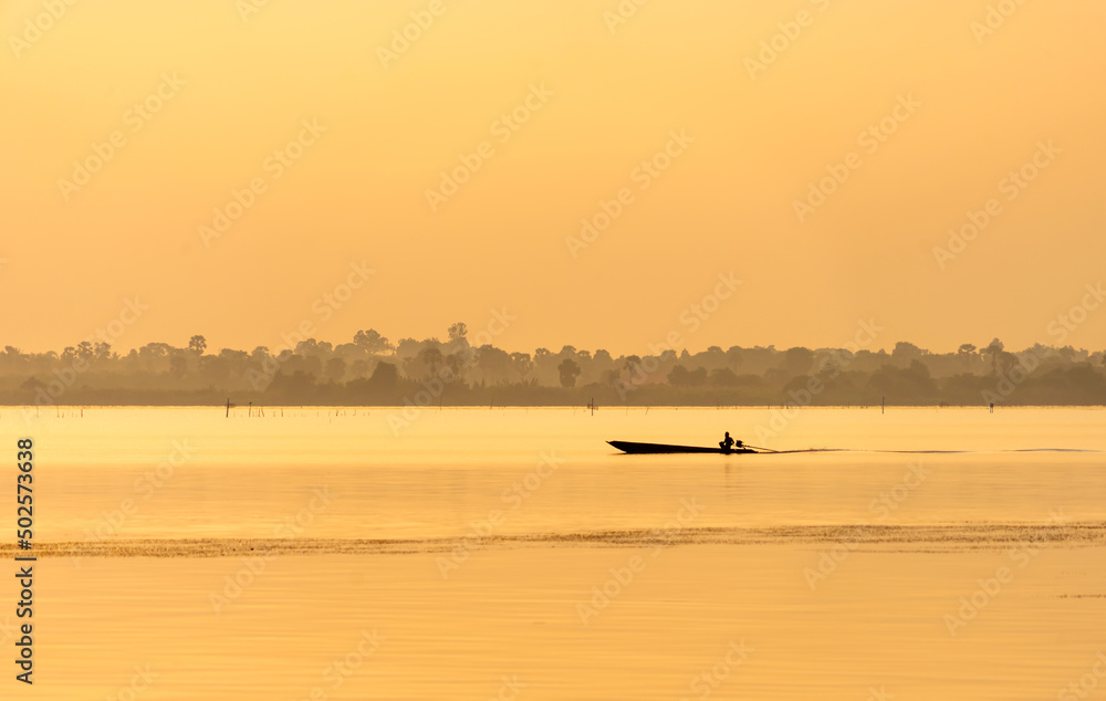 Fishermen sailing into port at sunset. Fishermen sailing into port at sunset.