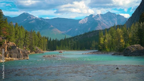 Bow River with raft and tourists near the village of Banff in Alberta, Canada