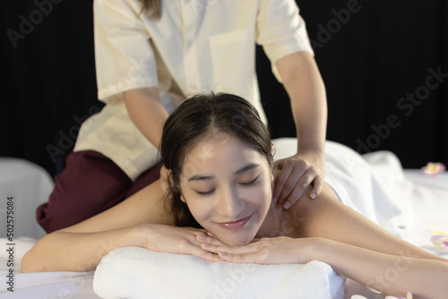 Young woman resting in luxurious spa and enjoying relaxing massage