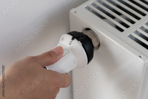 The white thermostat for adjusting the central heating radiator is set to the maximum temperature maintenance mode in the room