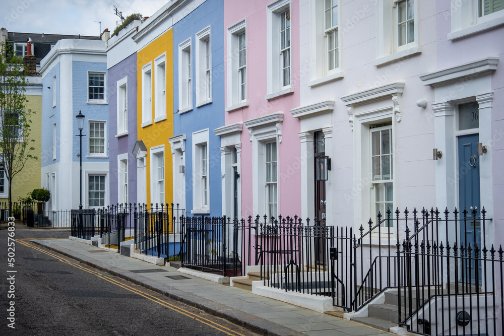 Colourful street of upmarket townhouses in Notting Hill area of West London