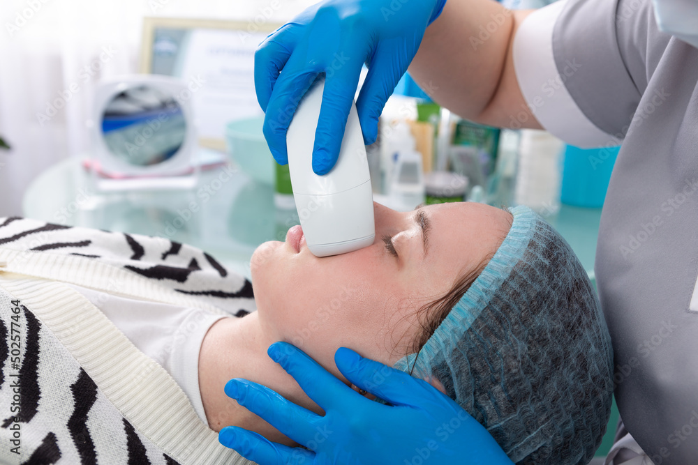 Young woman receiving electric galvanic anti-aging face spa massage at beauty salon. Young woman receiving electric galvanic anti-aging face spa massage at beauty salon.