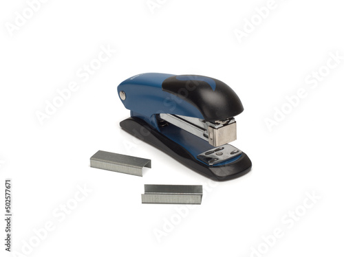 Photo of stapler on white background and staples nearby