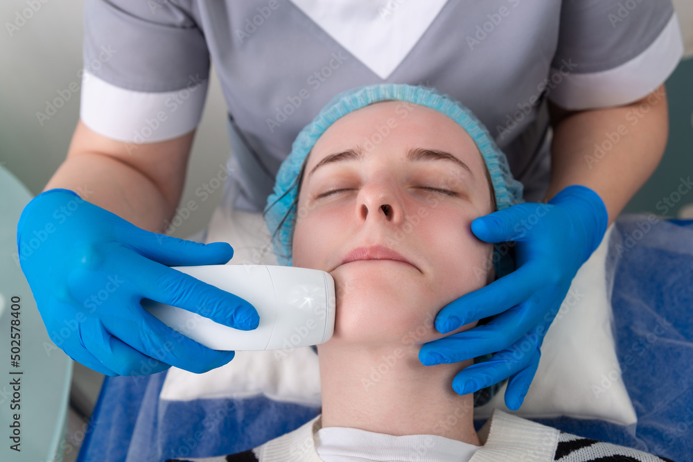 Young woman receiving electric galvanic anti-aging face spa massage at beauty salon. Young woman receiving electric galvanic anti-aging face spa massage at beauty salon.
