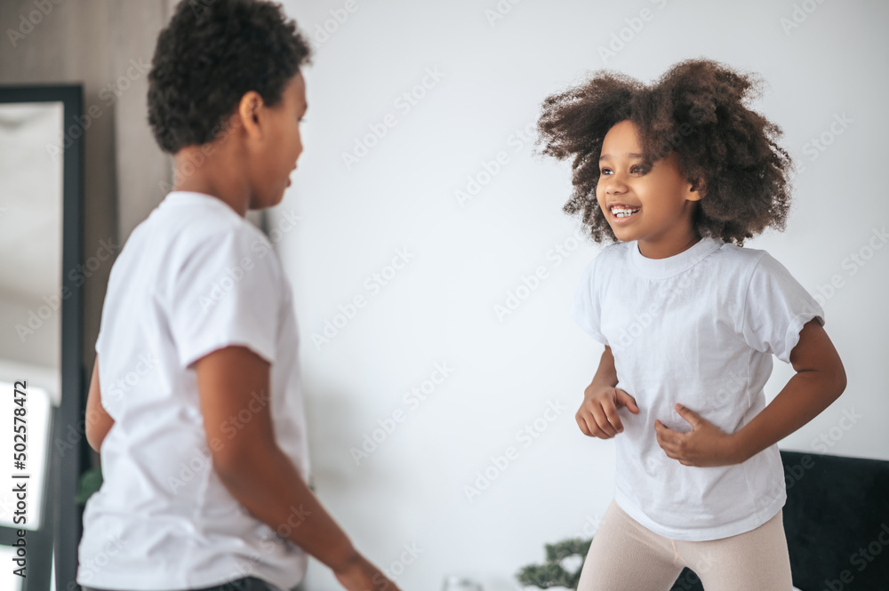 Two siblings playing together and looking excited Two siblings playing together and looking excited