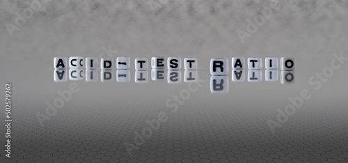 acid test ratio word or concept represented by black and white letter cubes on a grey horizon background stretching to infinity