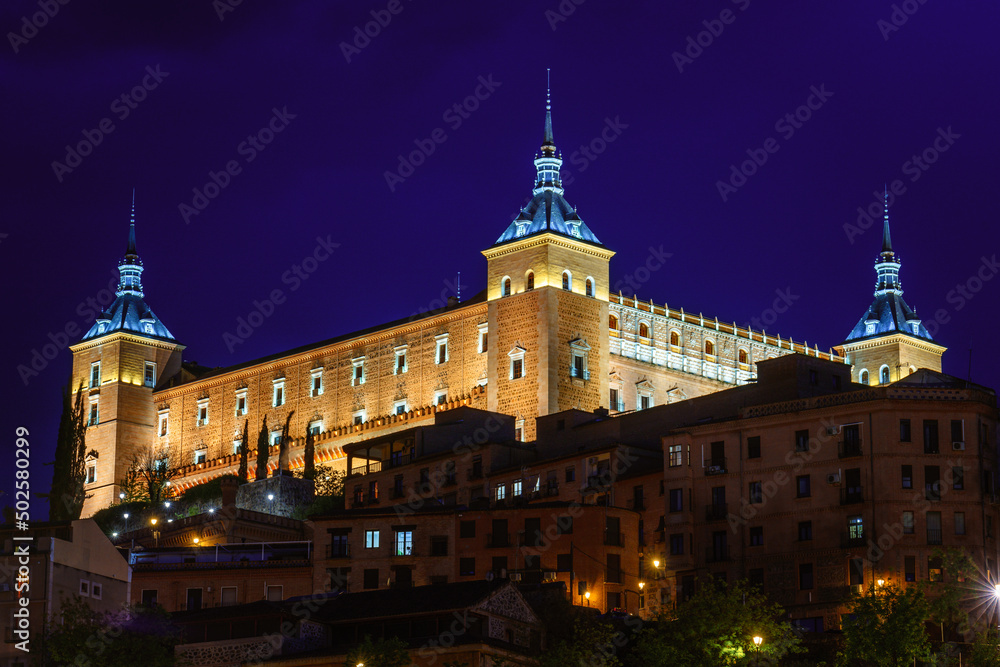 The Alcazar de Toledo illuminated by night. Historical landmark in Spain