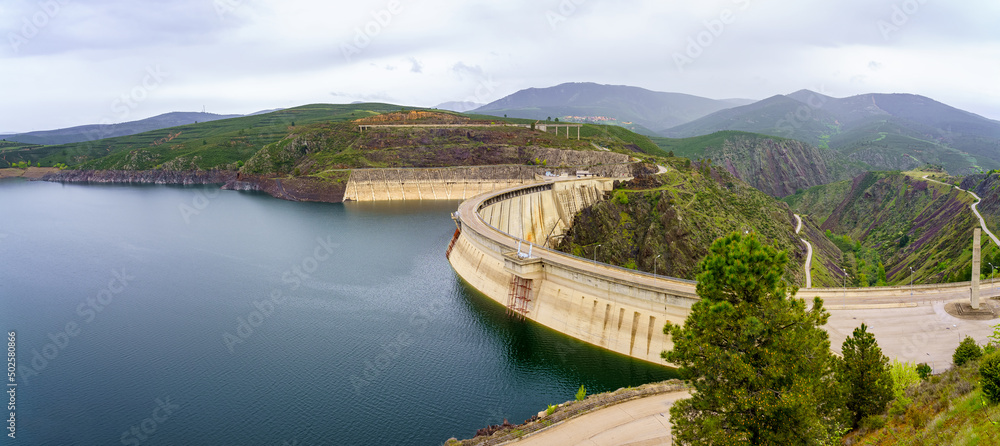 Panoramic reservoir between the green mountains with swamp dam containing the water, Atazar, Madrid.