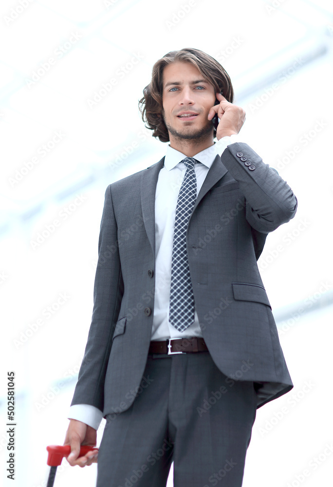 bottom view.businessman with Luggage talking on a cell bottom view.businessman with Luggage talking on a cell