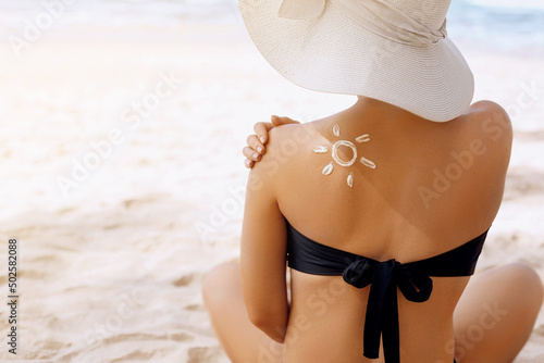 Suncream. Suntan Lotion Beautiful Woman Applying on beautiful on Shoulder. Sunscreen Solar Cream. Skin care. Sun protection photo