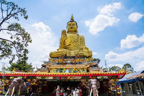 Nakhon Nayok, Thailand - April, 24, 2022 : Golden buddha statue of Maniwong Temple at Nakhon Nayok, Thailand.