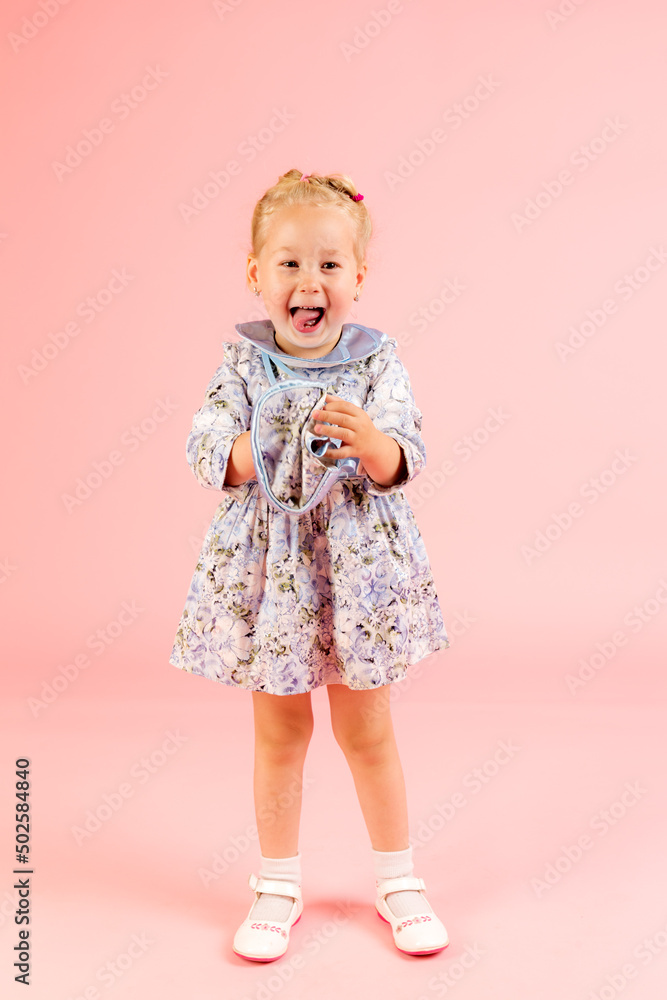 little cheerful girl on a pink background little cheerful girl on a pink background
