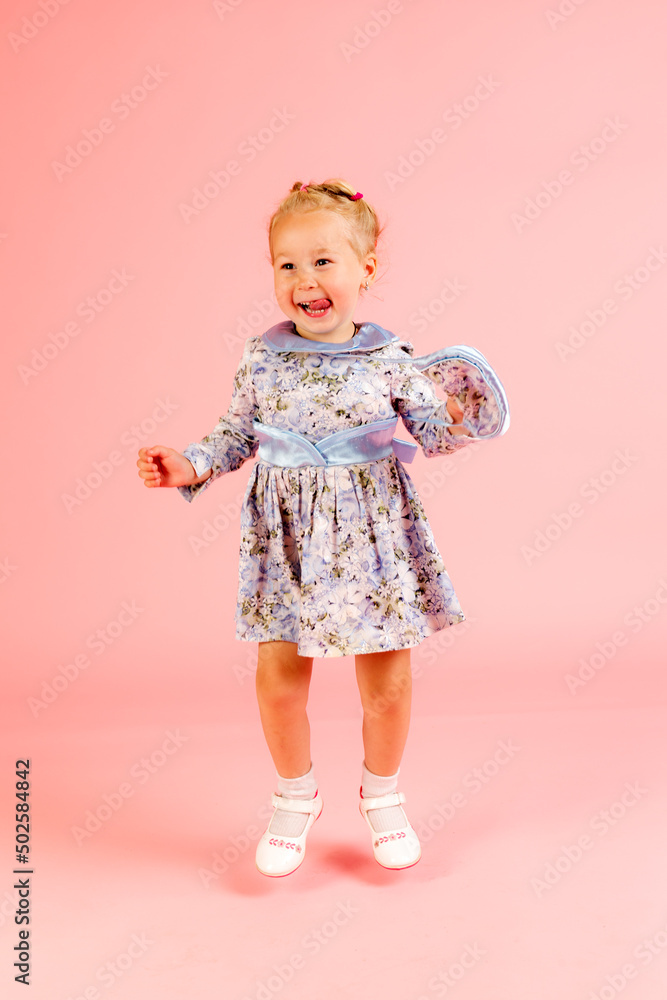 cheerful girl on a pink background