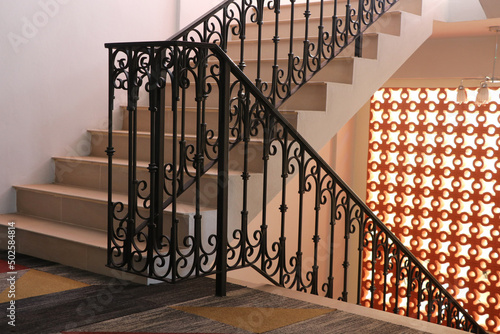 The vintage metal style, stair railing with  orange bricks light wall