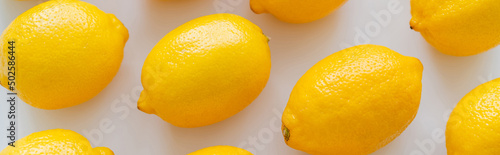 Fotografiet Flat lay with organic ripe lemons on white background, banner