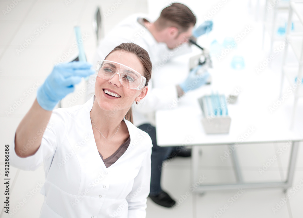 smiling scientist looking at the test results smiling scientist looking at the test results