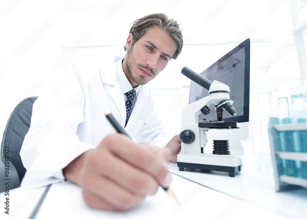 scientist makes a note of experiment in the laboratory