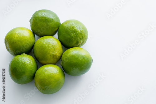 Fototapeta Naklejka Na Ścianę i Meble -  Top view of round limes on white background