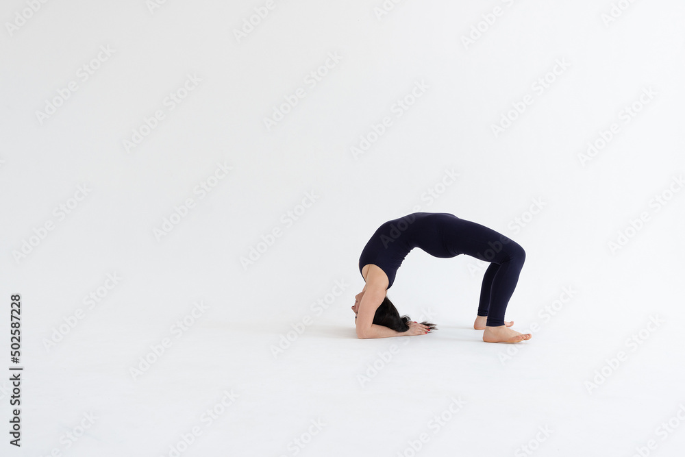 Sporty young woman doing yoga practice isolated on white background. Concept of healthy life and natural balance between body and mental development. Full length Sporty young woman doing yoga practice isolated on white background. Concept of healthy life and natural balance between body and mental development. Full length