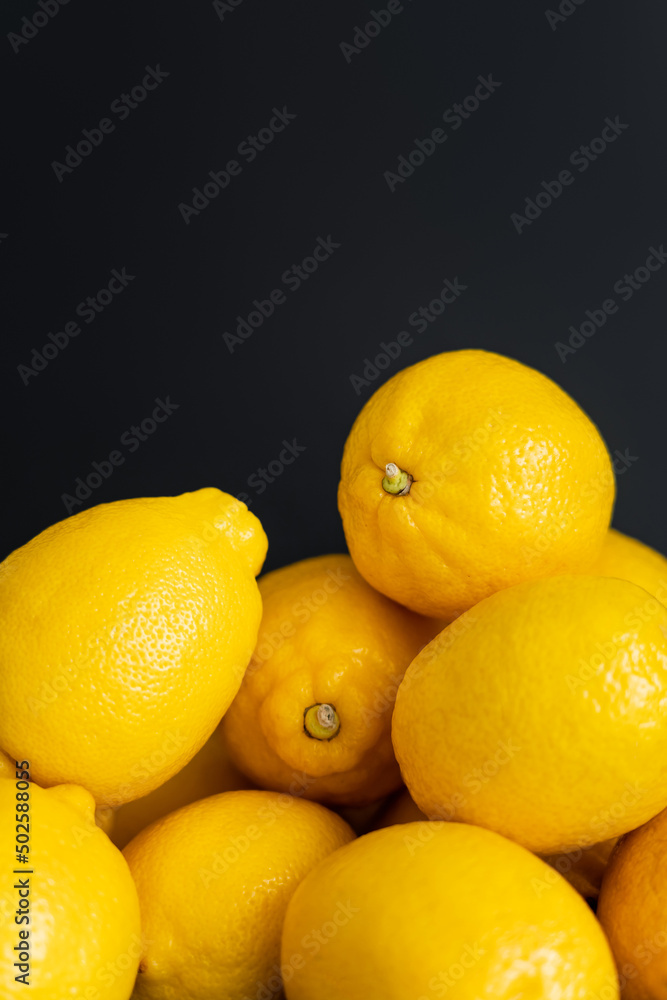 Close up view of organic lemons isolated on black with copy space Close up view of organic lemons isolated on black with copy space