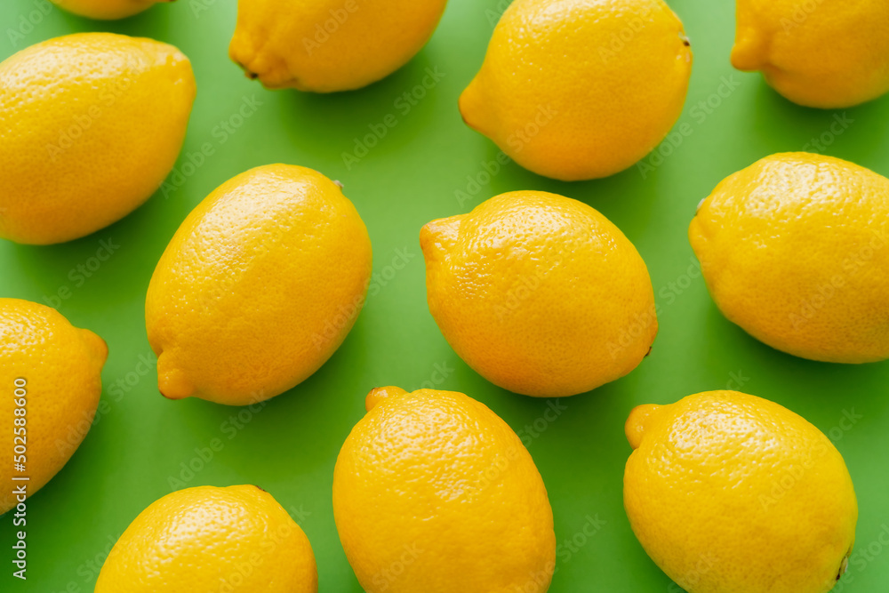 Top view of bright fresh lemons on green background Top view of bright fresh lemons on green background