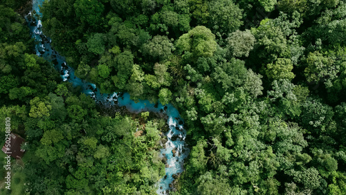 Tablou pe pânză Aerial view of the forest with a blue river in Costa Rica (Rio Celeste, La Fortu
