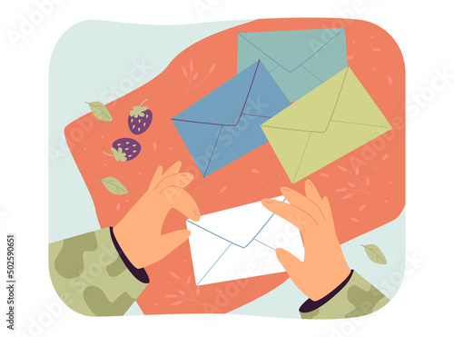 Hands of soldier holding paper envelope. Man in camouflage receiving letter flat vector illustration. Post service, delivery of information concept for banner, website design or landing web page