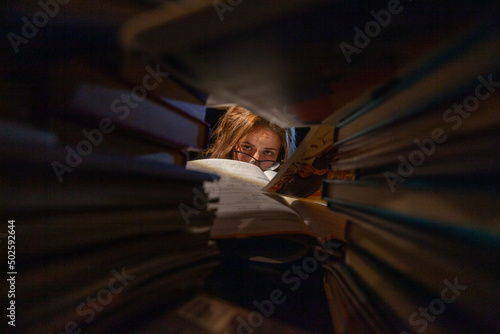 A woman studying in a library for her final exams.